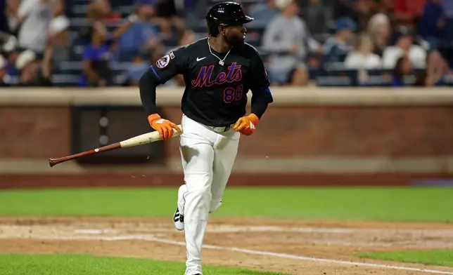 New York Mets Luis Robert Jr. watches his solo home run during the sixth inning of a baseball game against the Milwaukee Brewers on Tuesday, Aug. 25, 2026, in New York. (AP Photo/Adam Hunger)