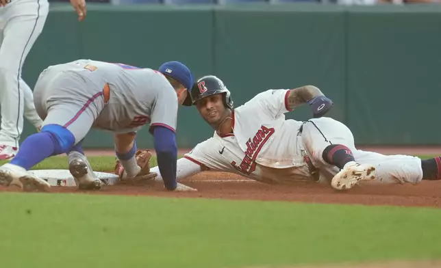 Cleveland Guardians' Brayan Rocchio, right, is tagged out at third base by New York Mets third baseman Bo Bichette, left, in the second inning of a baseball game in Cleveland, Tuesday, Aug. 4, 2026. (AP Photo/Sue Ogrocki)