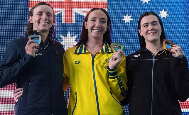 From left, silver medalist Katie Ledecky, of the United States, gold medalist Lani Pallister, of Australia, and bronze medalist Erika Fairweather, of New Zealand celebrate after the the women's 400 meters freestyle final at the Pan Pacific Swimming Championships Friday, Aug. 14, 2026 in Irvine, Calif. (AP Photo/Gregory Bull)