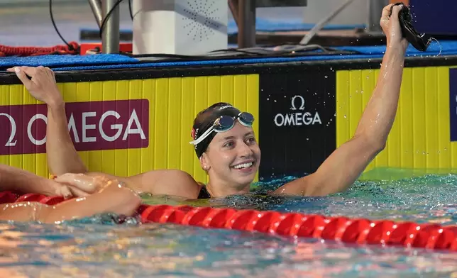 Kate Douglass, of the United States, smiles after winning the women's 50 meters freestyle final with a new world record at the Pan Pacific Swimming Championships Saturday, Aug. 15, 2026 in Irvine, Calif. (AP Photo/Gregory Bull)