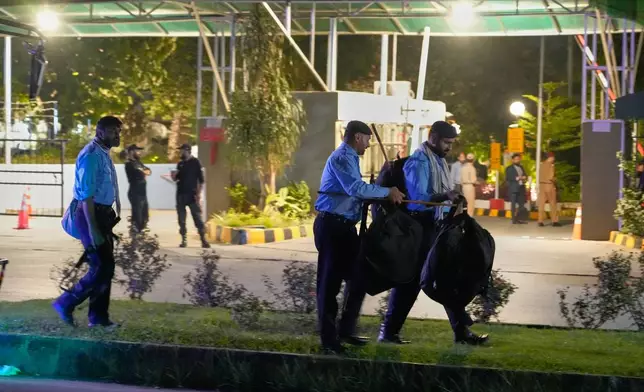 Police officers arrive to take position outside the Shifa International Hospital, where imprisoned former Prime Minister Imran Khan will be transferred for a medical examination following Pakistan's Supreme Court order, in Islamabad, Pakistan, Thursday, Aug. 20, 2026. (AP Photo/Anjum Naveed)