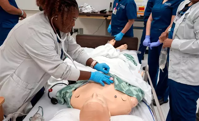 Nursing student Persis Coleman checks a manikin in the simulation lab at Forsyth Technical Community College in Winston-Salem, N.C., Thursday, Aug. 20, 2026. (AP Photo/Chuck Burton)