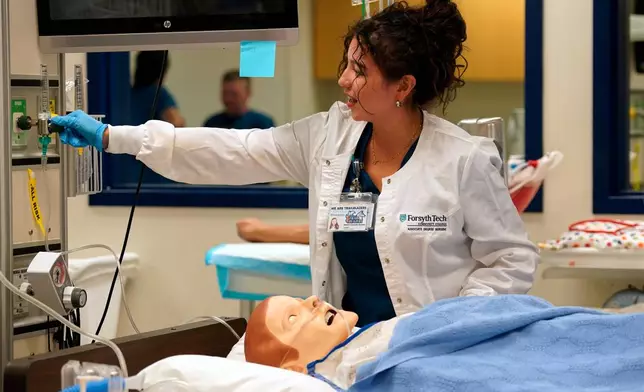 Nursing student Maribel Gonzalez Guzman checks a patient manikin in the simulation lab at Forsyth Technical Community College in Winston-Salem, N.C., Thursday, Aug. 20, 2026. (AP Photo/Chuck Burton)