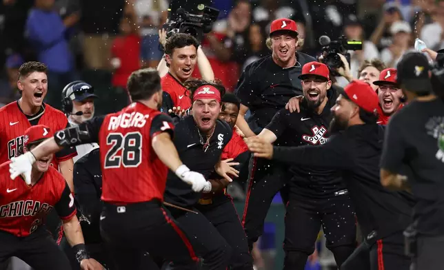 Chicago White Sox's Jake Rogers (28) celebrates with teammates after hitting a walk-off home run during the ninth inning of a baseball game against the New York Mets in Chicago, Friday, Aug. 21, 2026. (AP Photo/Jessie Alcheh)