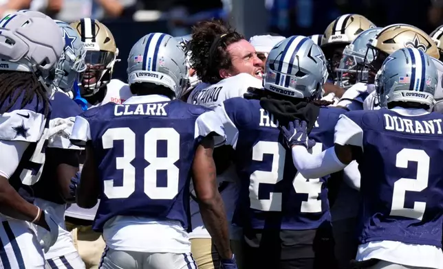 New Orleans Saints tight end Moliki Matavao, center, scuffle with members of the Dallas Cowboys during an NFL football joint practice, Tuesday, Aug. 18, 2026, in Oxnard, Calif. (AP Photo/Mark J. Terrill)