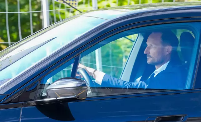 Norwegian Crown Prince Haakon drives a car on his way to the National Hospital in Oslo, Monday, Aug. 24, 2026. (Ole Berg Rusten/NTB Scanpix via AP)