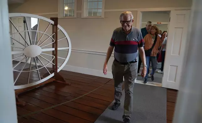 Visitors from around the country tour the third floor of the Kirtland temple, a nearly two-century old sanctuary considered the first temple in the movement Joseph Smith founded, on Wednesday, June 15, 2026, in Kirtland, Ohio. (AP Photo/Jessie Wardarski)