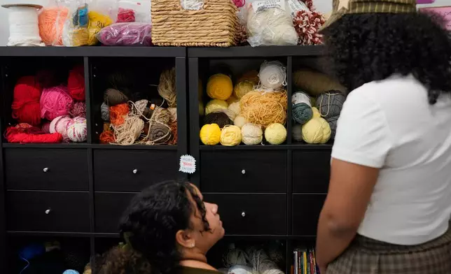 Yarn sits on shelves as shoppers debate items for sale at the Brooklyn Creative Reuse, Wednesday, July 29, 2026, in Brooklyn borough of New York. (AP Photo/Alyssa Goodman)