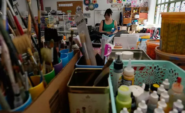A shopper looks through art supplies for sale at the Brooklyn Creative Reuse on Wednesday, July 29, 2026, in the Brooklyn borough of New York. (AP Photo/Alyssa Goodman)