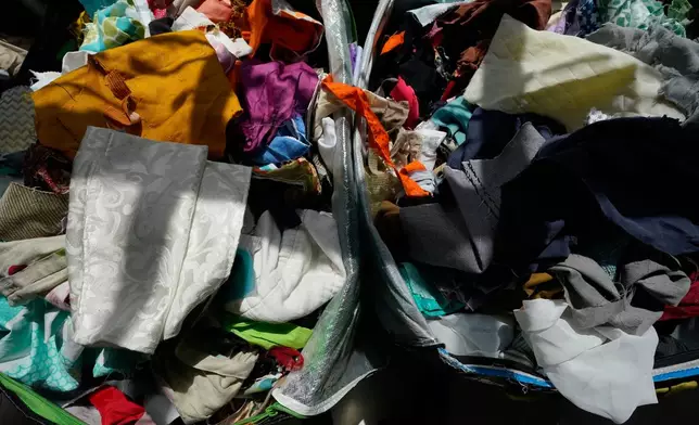 Fabric pieces sit for sale in bins at the Brooklyn Creative Reuse, Wednesday, July 29, 2026, in Brooklyn borough of New York. (AP Photo/Alyssa Goodman)