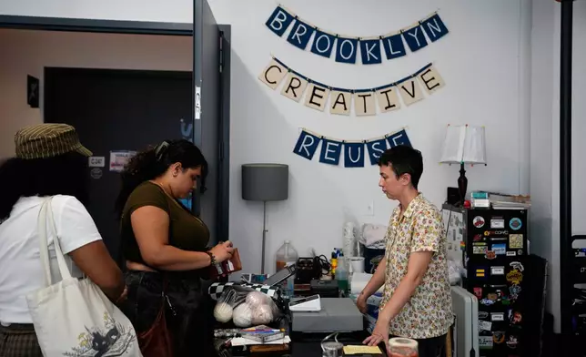 Stephanie O'Brien, right, helps shoppers pay for art supplies at the Brooklyn Creative Reuse, Wednesday, July 29, 2026, in Brooklyn borough of New York. (AP Photo/Alyssa Goodman)
