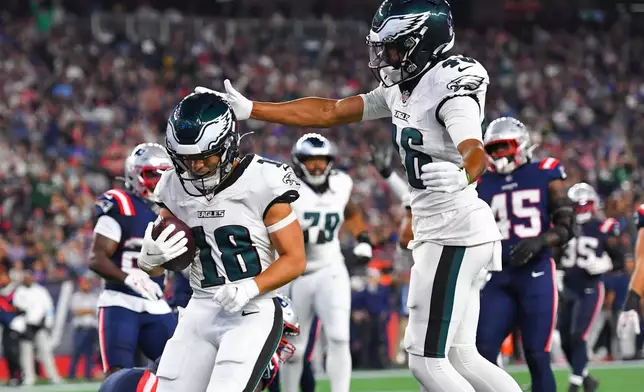 Philadelphia Eagles wide receiver Britain Covey (18) scores a touchdown as wide receiver Samori Toure celebrates against the New England Patriots during the first half of an NFL preseason football game, Saturday, Aug. 22, 2026, in Foxborough, Mass. (AP Photo/Steven Senne)