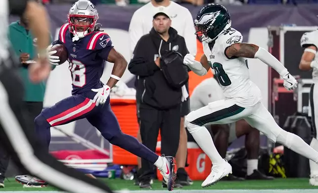 New England Patriots wide receiver Kyle Williams (18) runs for a touchdown as Philadelphia Eagles linebacker Jalyx Hunt (58) pursues during the first half of an NFL preseason football game, Saturday, Aug. 22, 2026, in Foxborough, Mass. (AP Photo/Robert F. Bukaty)