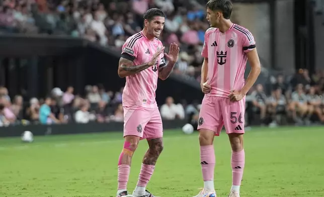 Inter Miami midfielder Rodrigo de Paul, left, talks with forward Daniel Pinter (56) during the first half of a Leagues Cup soccer match against Monterrey, Saturday, Aug. 8, 2026, in Miami. (AP Photo/Lynne Sladky)