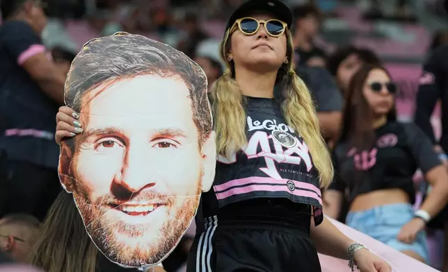 A fan holds a cutout face of Inter Miami forward Lionel Messi before a Leagues Cup soccer match between Inter Miami and Monterrey, Saturday, Aug. 8, 2026, in Miami. (AP Photo/Lynne Sladky)