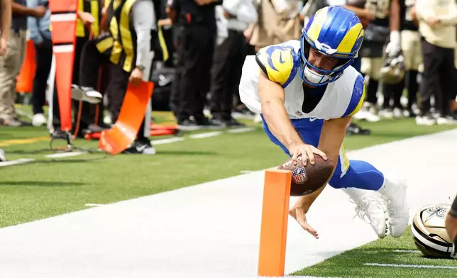 Los Angeles Rams quarterback Stetson Bennett reaches out to touch the pylon to score a touchdown during the first half an NFL preseason football game against the New Orleans Saints Saturday, Aug. 22, 2026, in Inglewood, Calif. (AP Photo/Caroline Brehman)