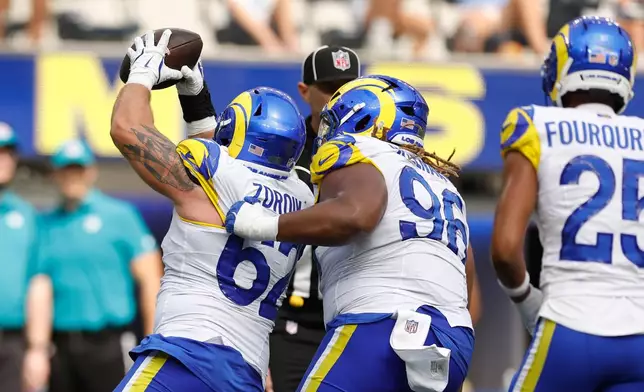 Los Angeles Rams defensive lineman Payton Zdroik (62) recovers a fumble during the second half an NFL preseason football game against the New Orleans Saints Saturday, Aug. 22, 2026, in Inglewood, Calif. (AP Photo/Caroline Brehman )