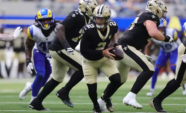 New Orleans Saints quarterback Spencer Rattler (2) rolls out of the pocket during the second half of an NFL preseason football game against the Los Angeles Rams Saturday, Aug. 22, 2026, in Inglewood, Calif. (AP Photo/Ryan Sun)
