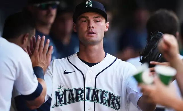 Seattle Mariners starting pitcher Kade Anderson is greeted in the dugout after facing the Chicago Cubs in the first inning of his major league debut in a baseball game, Saturday, Aug. 22, 2026, in Seattle. (AP Photo/Lindsey Wasson)