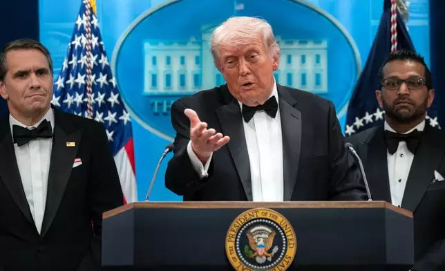 FILE - President Donald Trump speaks in the James Brady Press Briefing Room at the White House after a shooting incident outside the ballroom at at the annual White House Correspondents' Association dinner in Washington, April 25, 2026, as acting Attorney General Todd Blanche, left, and FBI director Kash Patel listen. (AP Photo/Jose Luis Magana, File)