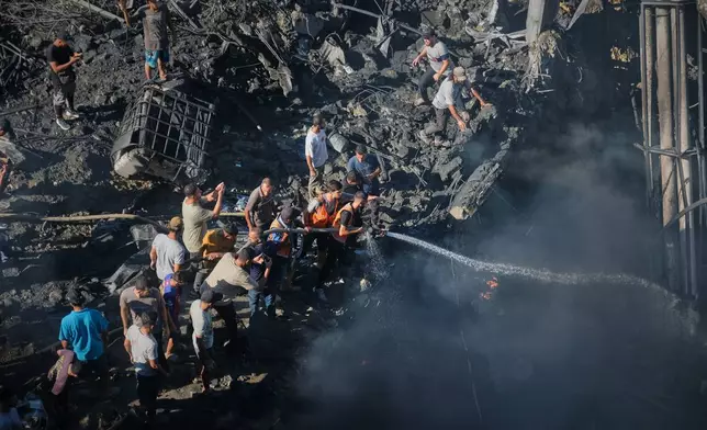 Palestinians try to extinguish a fire in the rubble of a destroyed building following an Israeli airstrike in Gaza City, Monday, Aug. 24, 2026. (AP Photo/Jehad Alshrafi)