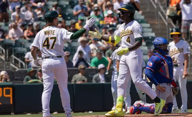 Athletics' Lawrence Butler (4) celebrates with Tommy White (47) after hitting a two-run home run during the second inning of a baseball game against the Texas Rangers, Sunday, Aug. 16, 2026, in West Sacramento, Calif. (AP Photo/Sara Nevis)