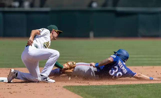 Athletics second baseman Alika Williams, left, tags out Texas Rangers' Cody Freeman (39) during the fourth inning of a baseball game Sunday, Aug. 16, 2026, in West Sacramento, Calif. (AP Photo/Sara Nevis)