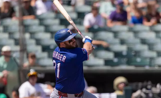 Texas Rangers' Jake Burger hits a home run during the second inning of a baseball game against the Athletics, Sunday, Aug. 16, 2026, in West Sacramento, Calif. (AP Photo/Sara Nevis)