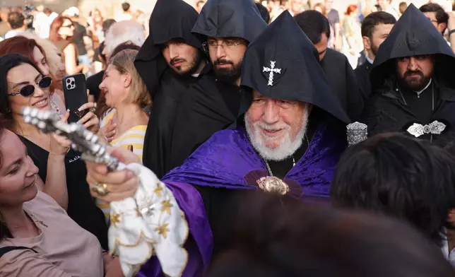 The head of the Armenian Apostolic Church Catholicos Karekin II, center, blesses people in Vagharshapat, Armenia, Friday, Aug. 7, 2026. (AP Photo/Anthony Pizzoferrato)