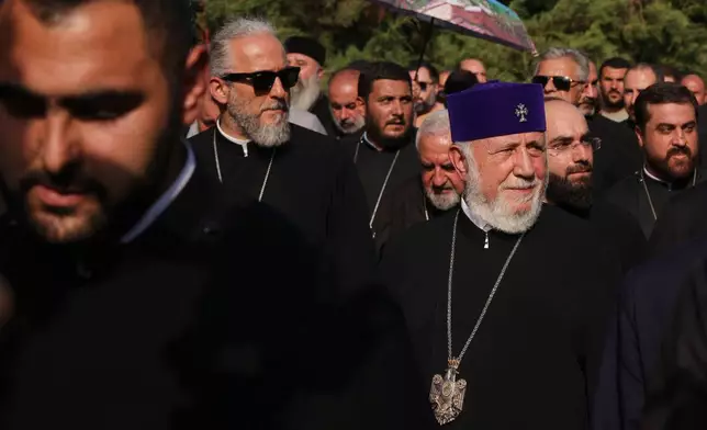 The head of the Armenian Apostolic Church Catholicos Karekin II, right, leaves the Armavir Court of First Instance in Vagharshapat, Armenia, Friday, Aug. 7, 2026. (AP Photo/Anthony Pizzoferrato)