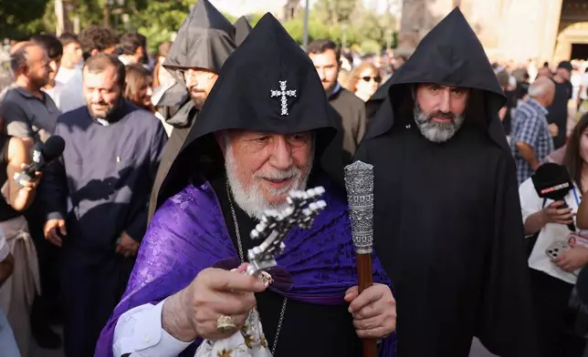 The head of the Armenian Apostolic Church Catholicos Karekin II, front, blesses people in Vagharshapat, Armenia, Friday, Aug. 7, 2026. (AP Photo/Anthony Pizzoferrato)