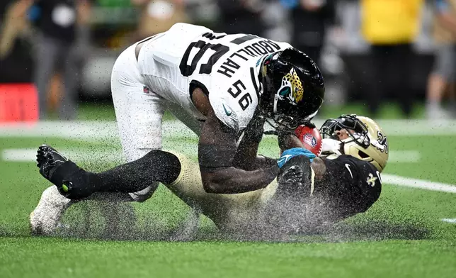 New Orleans Saints kick returner Barion Brown is stopped by Jacksonville Jaguars linebacker Yasir Abdullah (56) on a punt return during the first half of an NFL preseason football game Saturday, Aug. 15, 2026, in New Orleans. (AP Photo/Ella Hall)