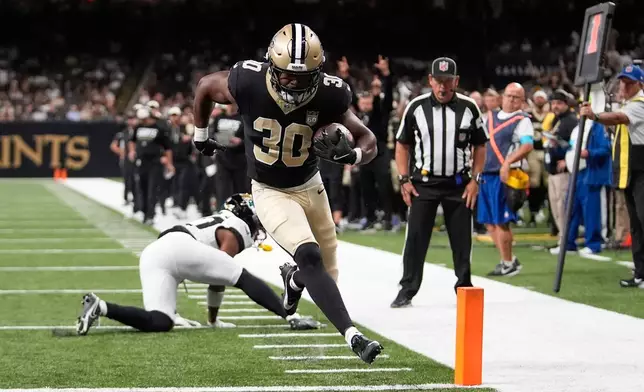 New Orleans Saints running back Audric Estimé (30) scores during the first half of an NFL preseason football game against the Jacksonville Jaguars Saturday, Aug. 15, 2026, in New Orleans. (AP Photo/Gerald Herbert)