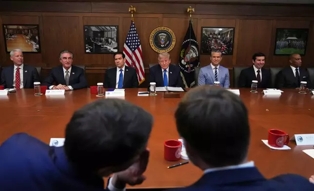 President Donald Trump, seated center, joined by Energy Secretary Chris Wright, from left, Interior Secretary Doug Burgum, Secretary of State Marco Rubio, Defense Secretary Pete Hegseth, acting Labor Secretary Keith Sonderling, and Housing and Urban Development Secretary Scott Turner, attends a cabinet meeting, Friday, July 31, 2026, at Camp David, the presidential retreat, near Thurmont, Md., Friday, July 31, 2026. (AP Photo/Jacquelyn Martin)