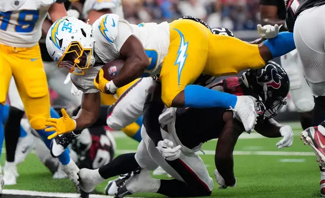 Los Angeles Chargers running back Amar Johnson (35) dives for a two-point conversion against the Houston Texans during the second half of an NFL preseason football game Thursday, Aug. 13, 2026, in Houston. (AP Photo/Ashley Landis)