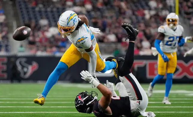 Los Angeles Chargers safety Genesis Smith (22) is called for interference as he breaks up a pass intended for Houston Texans tight end Marlin Klein (83) during the first half of an NFL preseason football game Thursday, Aug. 13, 2026, in Houston. (AP Photo/Ashley Landis)