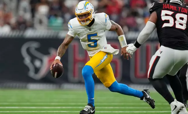 Los Angeles Chargers quarterback Trey Lance (5) runs past Houston Texans defensive tackle Kyonte Hamilton (58) during the second half of an NFL preseason football game Thursday, Aug. 13, 2026, in Houston. (AP Photo/Ashley Landis)