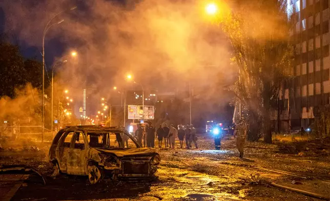 A burned car is seen after a Russian missile attack in Kyiv, Ukraine, Saturday, Aug. 1, 2026. (AP Photo/Dan Bashakov)