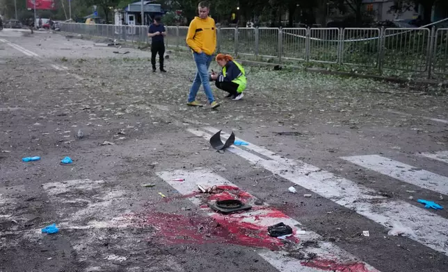 Blood and debris seen on the ground after a Russian missile attacks in Kyiv, Ukraine, Saturday, Aug. 1, 2026. (AP Photo/Efrem Lukatsky)