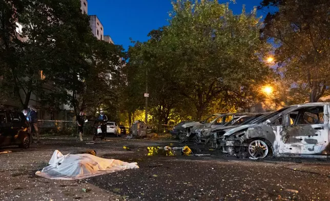 A body lies on the ground after a Russian missile attack in Kyiv, Ukraine, Saturday, Aug. 1, 2026. (AP Photo/Dan Bashakov)