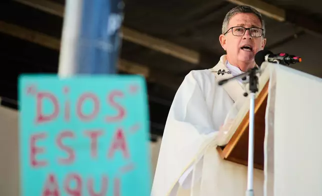 Archbishop Jorge Garcia Cuerva celebrates an outdoor Mass outside the Church of San Cayetano during the annual pilgrimage honoring Saint Cajetan, the patron saint of work, in Buenos Aires, Argentina, Friday, Aug. 7, 2026. (AP Photo/Natacha Pisarenko)