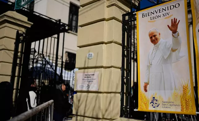 A banner of Pope Leo XIV is posted outside the Church of San Cayetano during the annual pilgrimage honoring Saint Cajetan, the patron saint of work, in Buenos Aires, Argentina, Friday, Aug. 7, 2026. (AP Photo/Natacha Pisarenko)