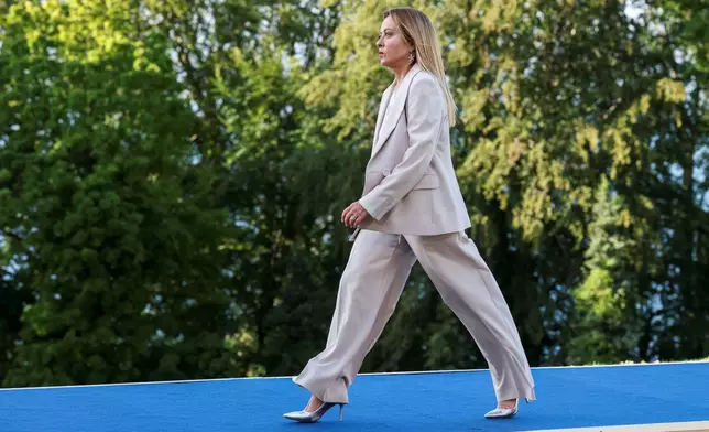 FILE - Italy's Prime Minister Giorgia Meloni walks during the official arrivals ceremony for the G7 summit in Evian-les-Bains, France, Monday, June 15, 2026. (Isabel Infantes, Pool Photo via AP, File)