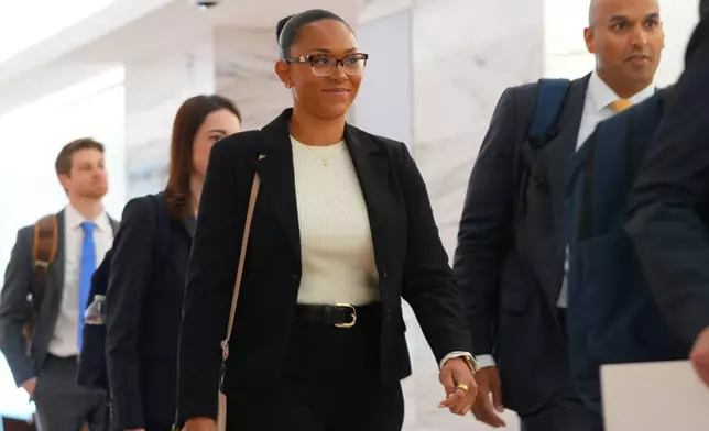 McKenna West, left, arrivers with her legal team for a court hearing in Dallas, Tuesday, Aug. 25, 2026. (AP Photo/LM Otero)