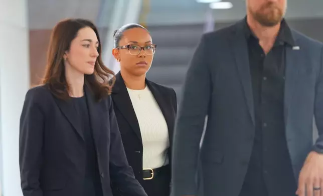 McKenna West, center, walks in a hallway before a court hearing in Dallas, Tuesday, Aug. 25, 2026. (AP Photo/LM Otero)