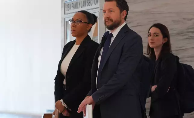 McKenna West, left, arrivers with her legal team for a court hearing in Dallas, Tuesday, Aug. 25, 2026. (AP Photo/LM Otero)