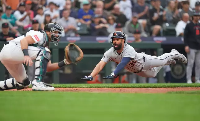 Detroit Tigers Riley Greene (31) dives to home and scores off a two run single from Colt Keith against the Seattle Mariners during the top of the third inning of a baseball game, Tuesday, Aug. 4, 2026, in Seattle. (AP Photo/Eric Hiller)