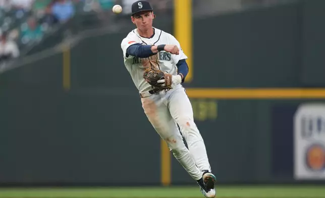 Seattle Mariners infielder Colt Emerson throws to first off a ground ball from Detroit Tigers Javier Báez during the top of the fourth inning of a baseball game, Tuesday, Aug. 4, 2026, in Seattle. (AP Photo/Eric Hiller)