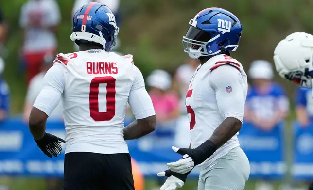 New York Giants' Brian Burns and Kayvon Thibodeaux talks at practice during an NFL football training camp, Saturday, Aug. 1, 2026, in White Sulphur Springs, W.Va. (AP Photo/Chris Carlson)