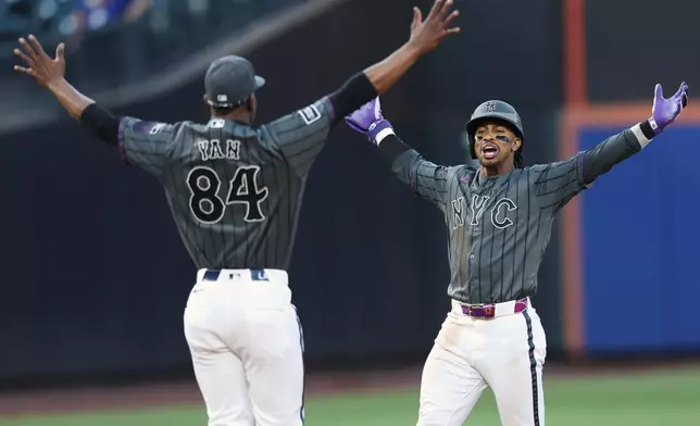 New York Mets' Francisco Lindor celebrates his game winning base hit with pitcher Jefry Yan (84) during the ninth inning of a baseball game against the Washington Nationals, Saturday, Aug. 15, 2026, in New York. (AP Photo/Heather Khalifa)
